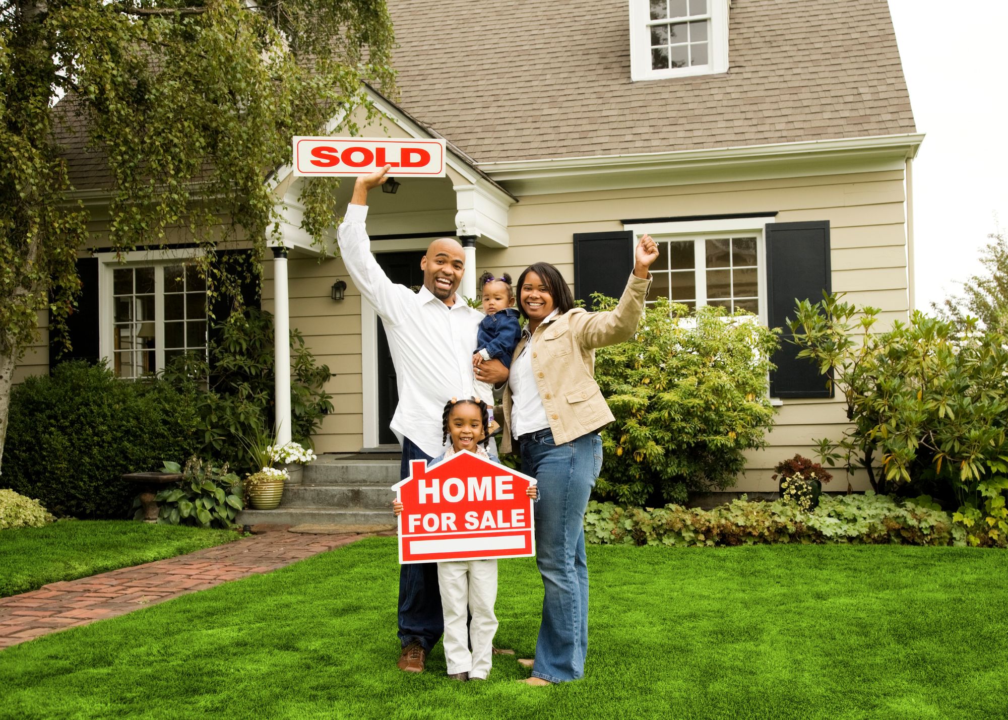 Happy family celebrating the purchase of their home.