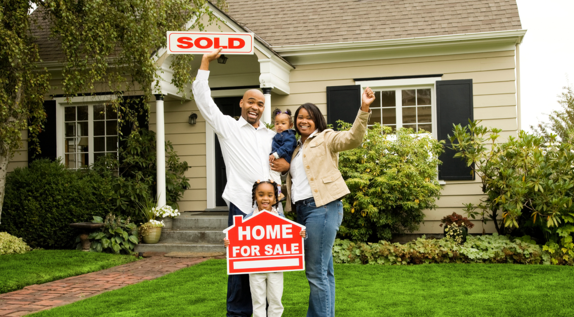 Happy family celebrating the purchase of their home.